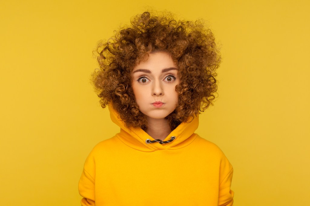 There are several ways to achieve the mammalian dive reflex, including holding your breath while pressing a bag of frozen vegetables to your face. Here, a woman in a yellow hood holds her breath.