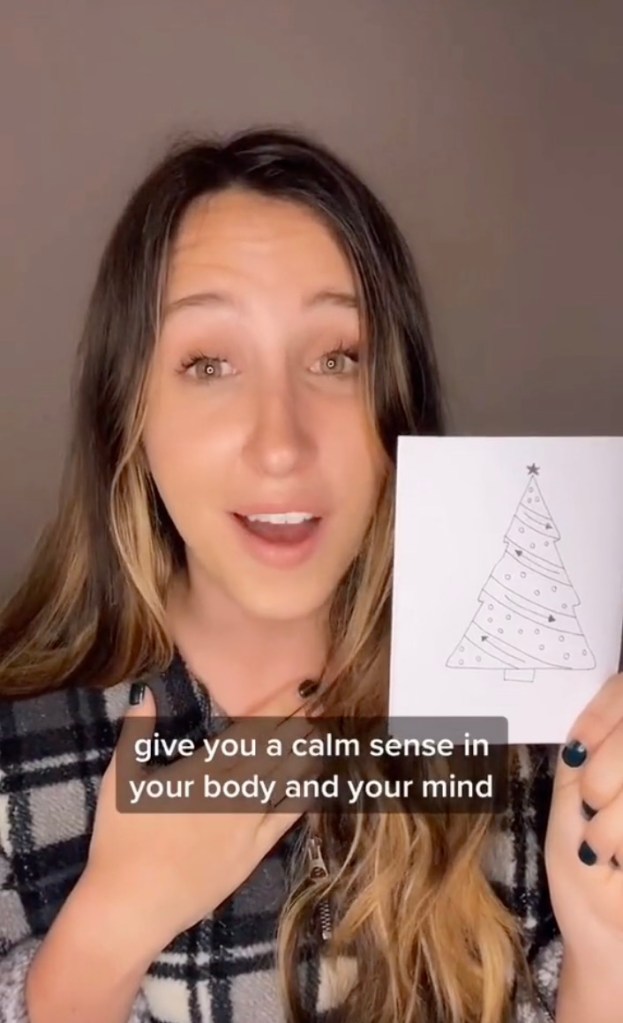 Maddie Spear (pictured here on TikTok with her drawing), a licensed social worker and therapist specializing in trauma, PTSD, anxiety and coping skills, suggests drawing a Christmas tree to ease anxiety.