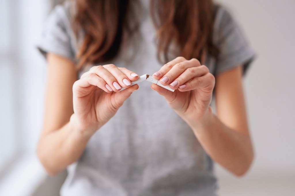 The woman breaking a cigarette