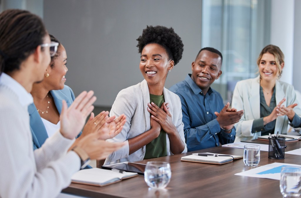 Black woman, success or applause of business people in a meeting