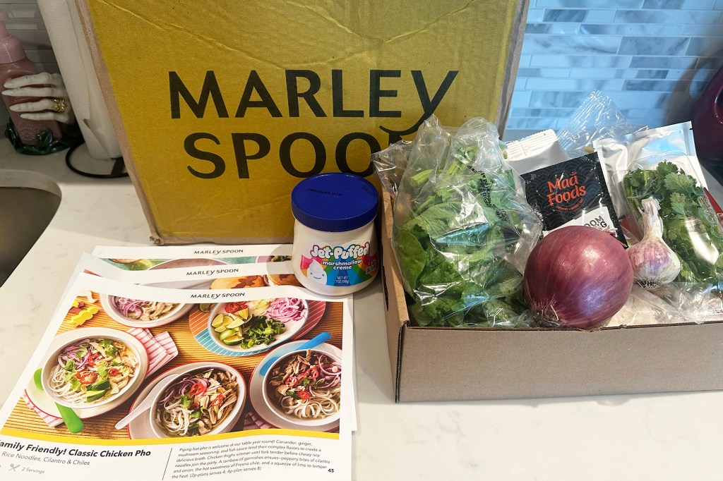 A box filled with food items next to a book