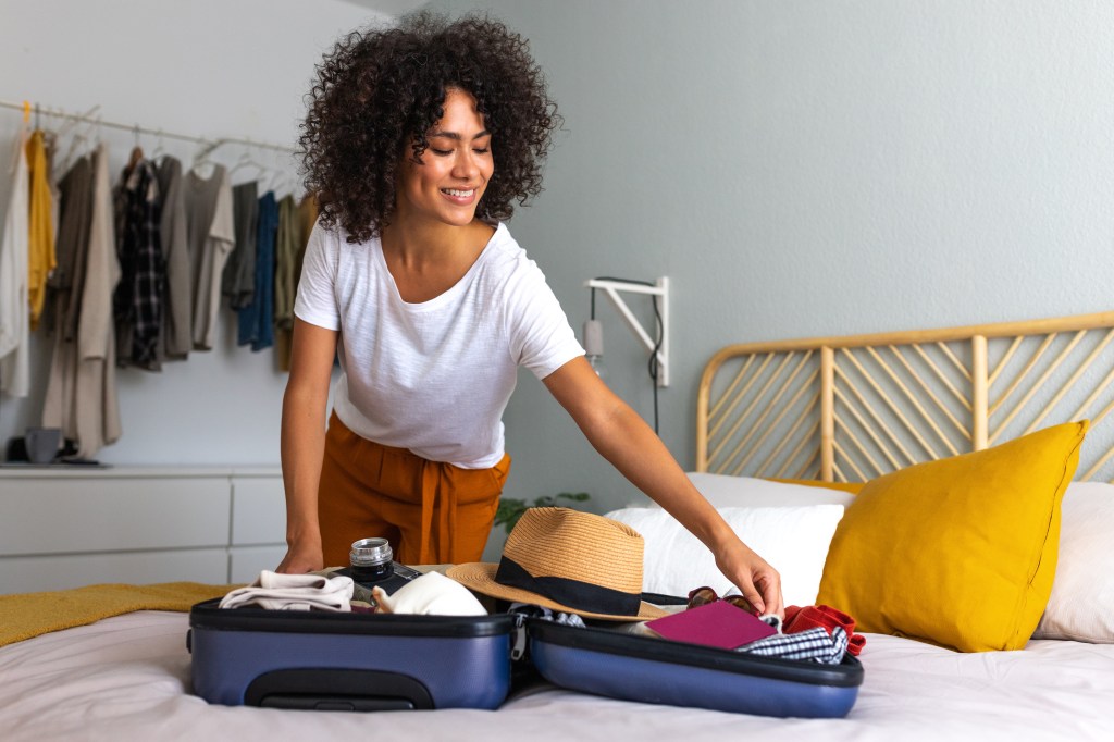 Woman packing a suitcase for vacation